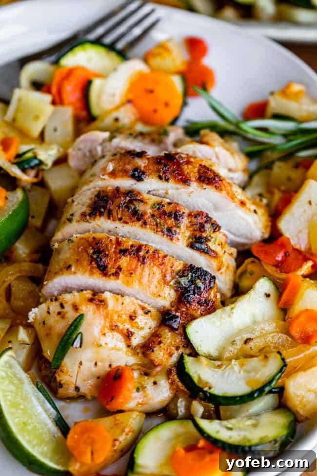 Sheet Pan Rosemary Lime Chicken and Veggies Sizzling rosemary chicken thighs getting a beautiful sear in a hot skillet before going into the oven.