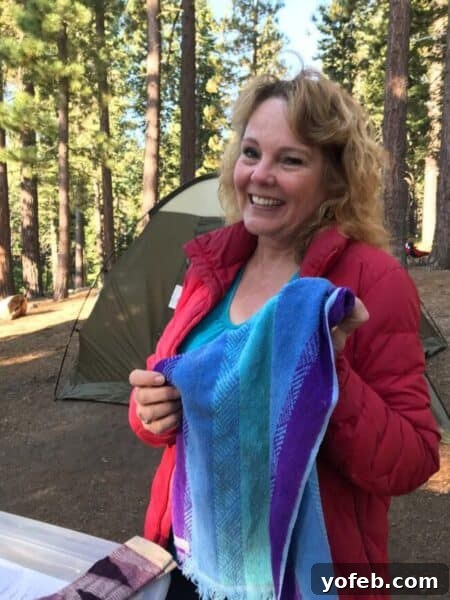 A charming glimpse into a family's history. A cheerful mother holding up a blue and purple hand towel, smiling.