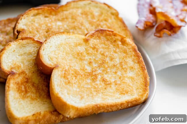 Crafting the Flawless BLT 6 toasted white bread with butter on a white plate