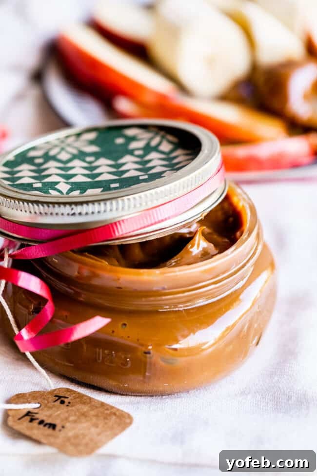 A small mason jar filled with dulce de leche, tied with a gift tag, making a charming and edible present.
