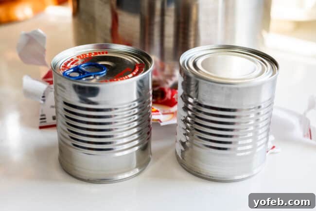 Unlabeled cans of sweetened condensed milk, prepared and ready to be cooked into dulce de leche.