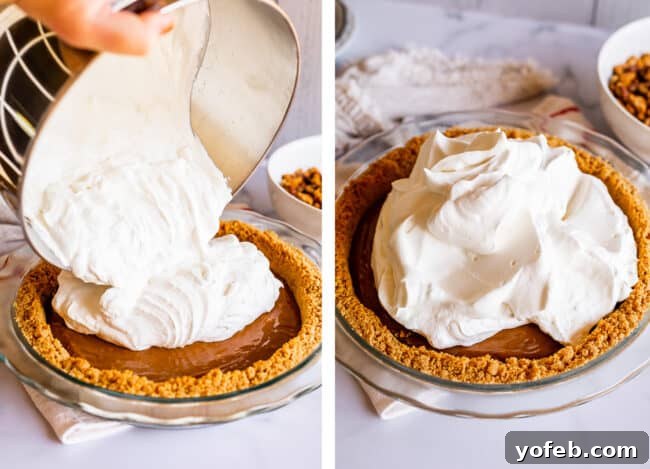Adding Salted Dulce de Leche to Your Pie A spoon smoothing a thick layer of salted dulce de leche into a baked graham cracker pie crust, showcasing the creamy filling.