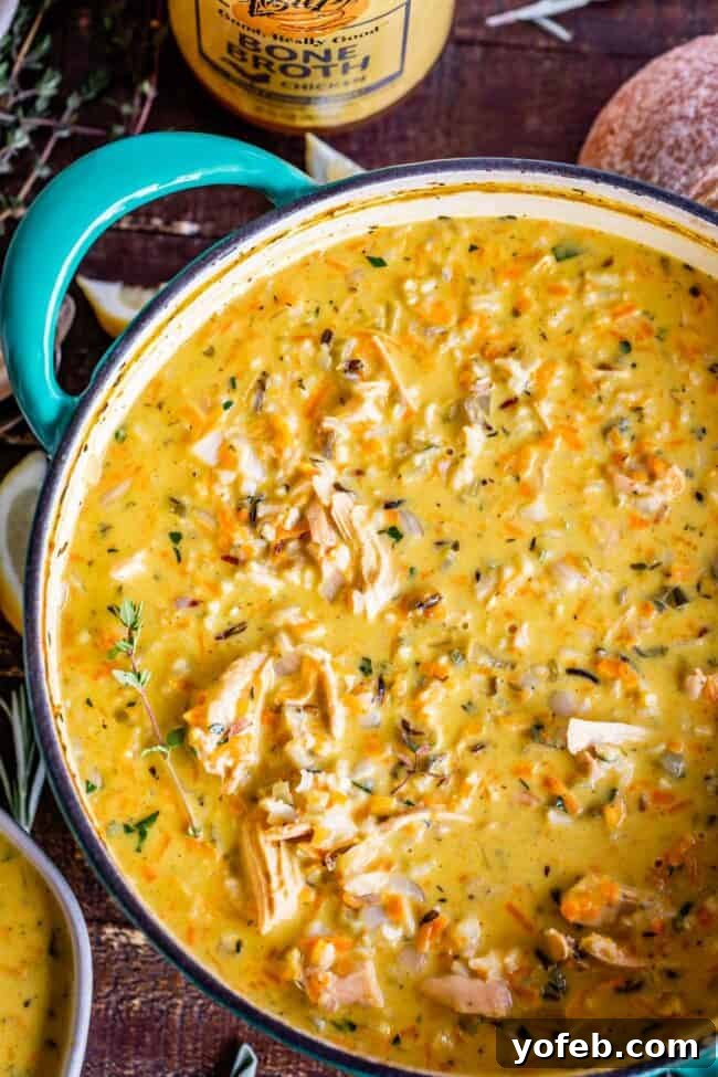 Slow Cooker Creamy Turkey Wild Rice Soup - perfect for easy weeknight meals or holiday leftovers. Creamy Turkey Wild Rice Soup simmering gently in a vibrant blue crockpot, illustrating the slow cooker method for this comforting dish.