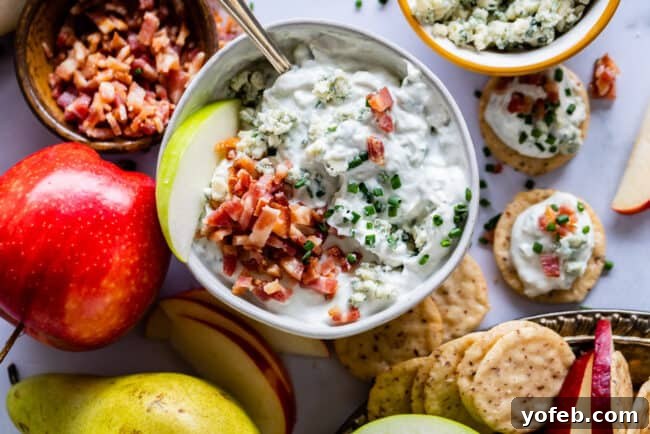 Healthy Cold Blue Cheese Dip with Fruit A serving of cold blue cheese dipping sauce with fresh apple slices, highlighting healthy and delicious options.