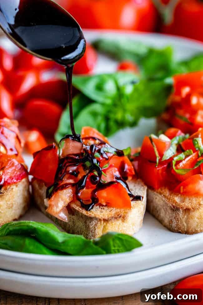 Balsamic Glaze on Bruschetta Appetizer Balsamic vinegar reduction gracefully drizzling onto bruschetta, artfully arranged on stacked white plates atop a wooden cutting board.