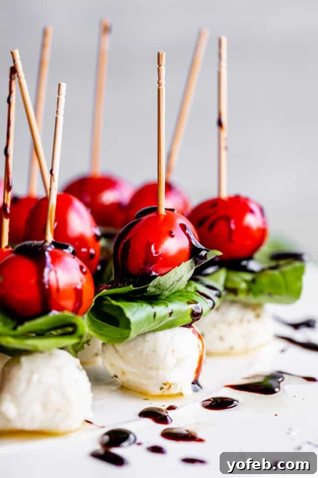 Tomato Mozzarella Basil Skewers Tomato, mozzarella, and basil skewers artfully arranged on a serving dish, highlighting the fresh ingredients.