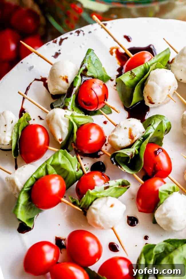 Caprese Salad Skewers Close-up of freshly prepared Caprese Salad Skewers with a glistening balsamic glaze, ready for serving.