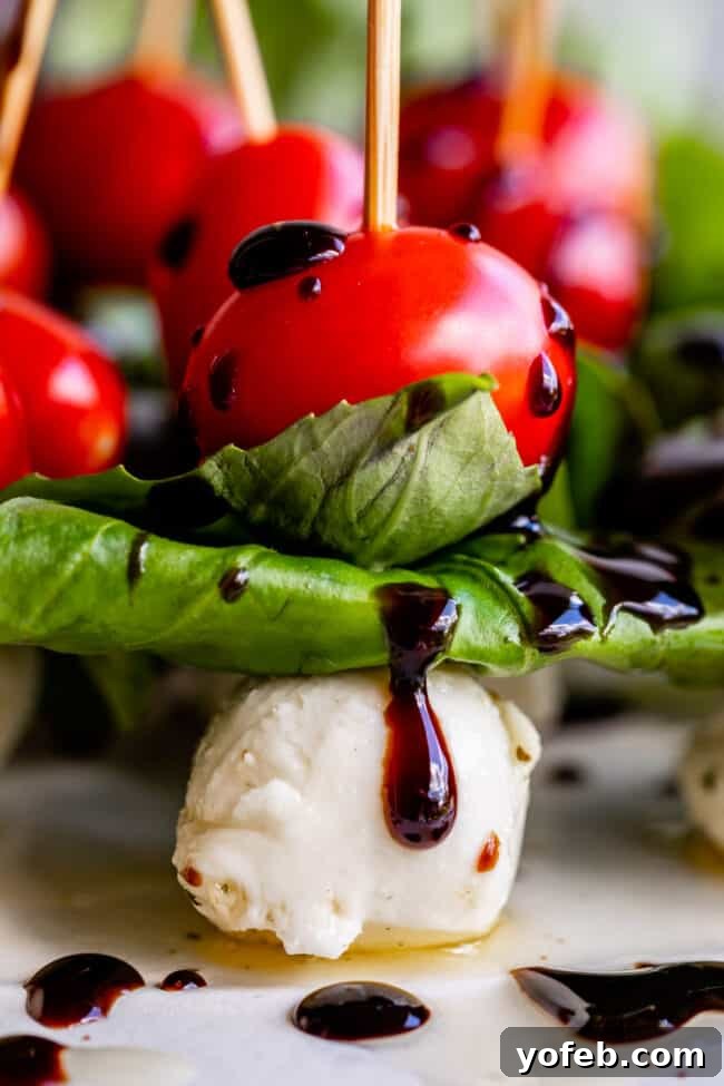 Caprese Appetizer Individual Caprese appetizer bites featuring cherry tomatoes, mozzarella, and basil, perfect for finger food.