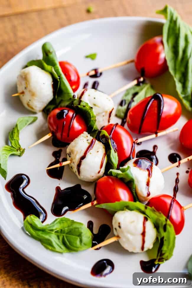 Caprese Bites Caprese skewers arranged on a rustic wooden board, showcasing their vibrant colors and appealing presentation.