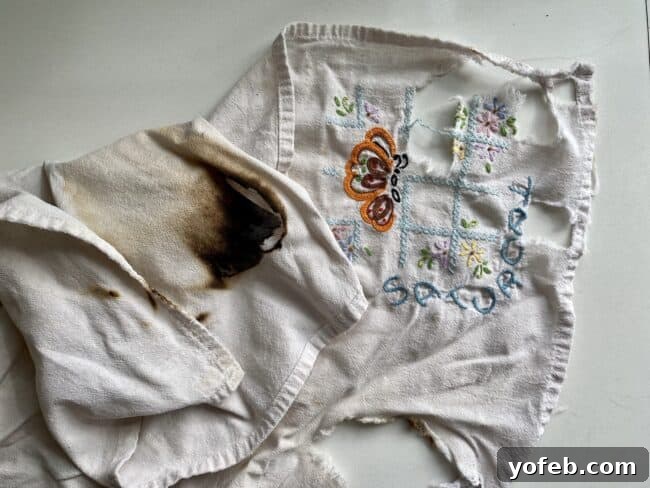 Effortless One-Hour Dinner Rolls 2 A burnt, embroidered dishcloth, showing signs of age and a recent mishap.