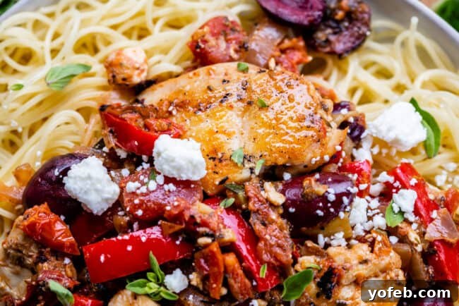 Serving Greek Chicken Pasta Individual serving of Greek chicken pasta, showing the rich sauce, tender chicken, and colorful vegetables nestled on a bed of pasta, a wholesome and satisfying meal.