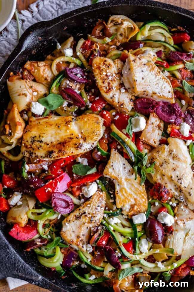 Delicious Greek Chicken Pasta Dish Plated Greek spaghetti or pasta with chicken and a rich vegetable sauce, garnished with fresh herbs and feta cheese, ready to be enjoyed as a quick and healthy meal.