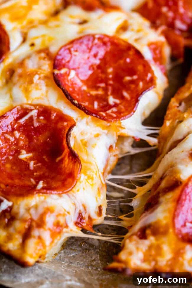 A delectable homemade pan pizza, generously topped with melted cheese and crispy pepperoni, ready to be enjoyed.