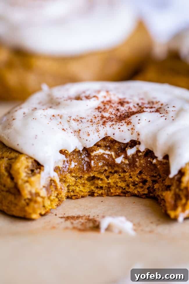Elegantly iced pumpkin cookies, with a delicate glaze that enhances their soft and cakey texture. Iced pumpkin cookies arranged beautifully, highlighting the smooth glaze and warm autumn colors