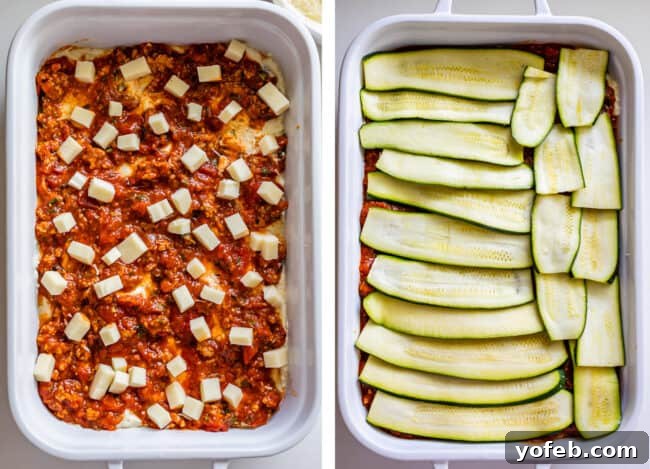 A white casserole dish featuring a layer of marinara sauce topped with cubed mozzarella cheese, followed by the next layer of thinly sliced zucchini noodles. This step in assembling zucchini lasagna demonstrates the progression of building flavor and texture within the dish.