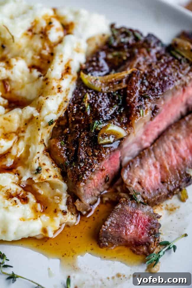 Grilled ribeye steak recipe served on a plate with fluffy mashed potatoes, garnished for a perfect meal.