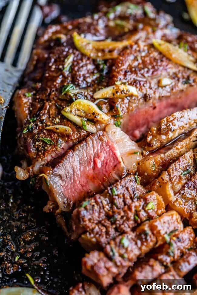 Perfectly pan-fried sliced ribeye steak showcasing its tender, juicy interior.