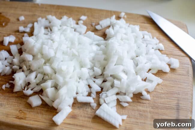 chopped white onions on a cutting board.