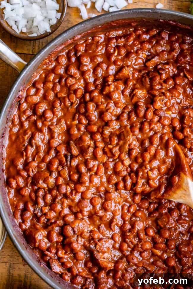 pinquito beans in a pan with a spoon.