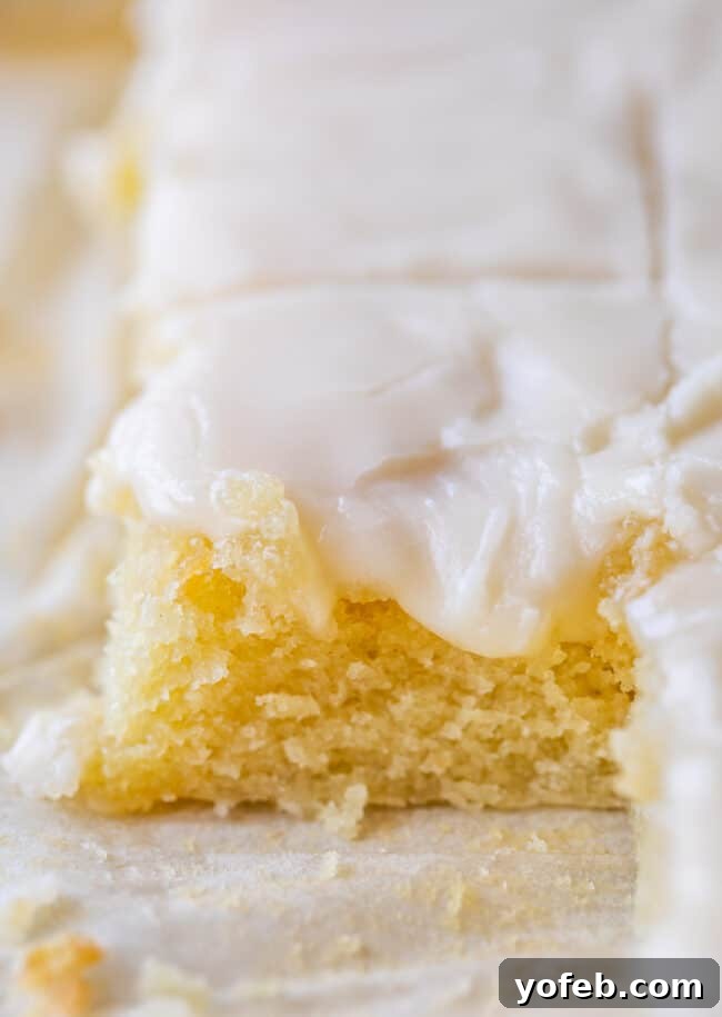 White Texas Sheet Cake Slices Individual slices of moist white Texas sheet cake on a platter