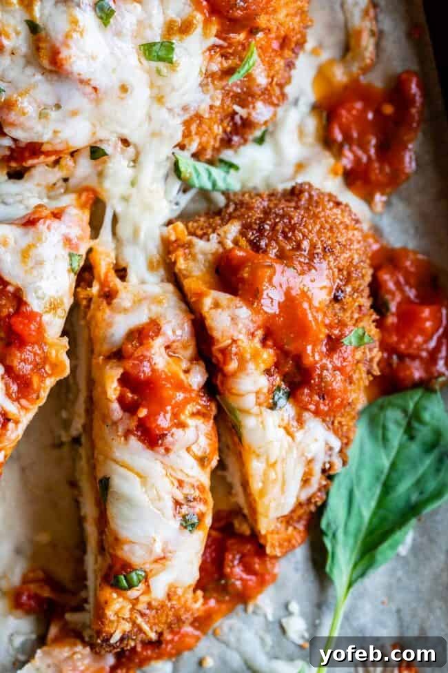 Heavenly Chicken Parmesan 16 best chicken parmesan recipe sliced on a pan and shot from overhead.