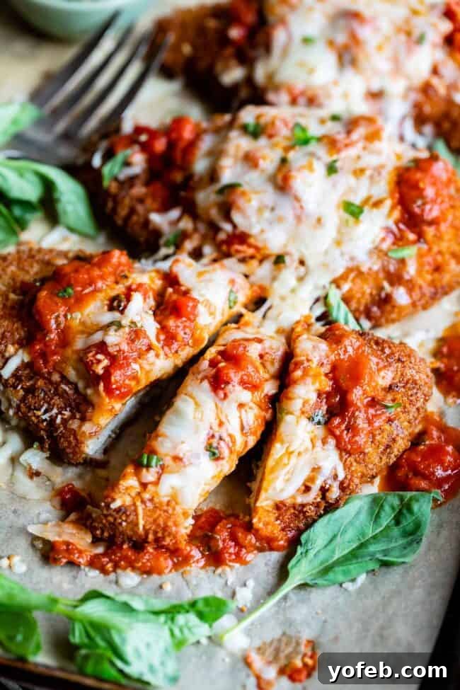 Heavenly Chicken Parmesan 7 easy chicken parm, cut into strips with a fork in the background.