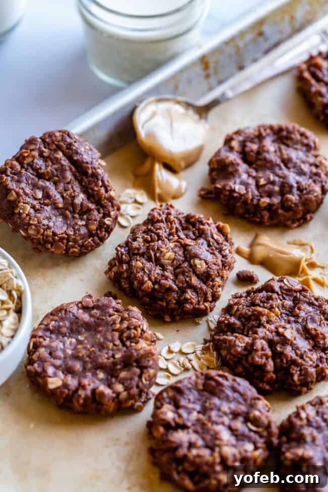 Easy No-Bake Peanut Butter Oatmeal Cookies 8 classic no bake cookies on a baking sheet with oats and peanut butter