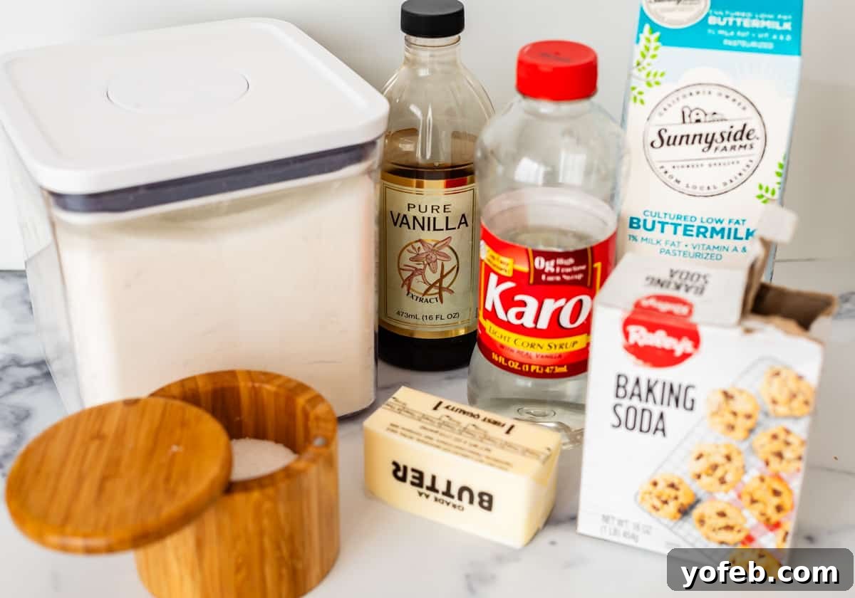 Velvet Smooth Buttermilk Syrup 6 Sugar, vanilla, karo syrup, buttermilk, baking soda, butter, and salt on a white countertop.