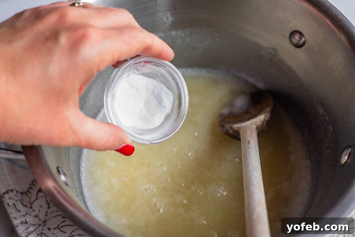 Velvet Smooth Buttermilk Syrup 8 Adding baking soda to a pot of boiling liquid.