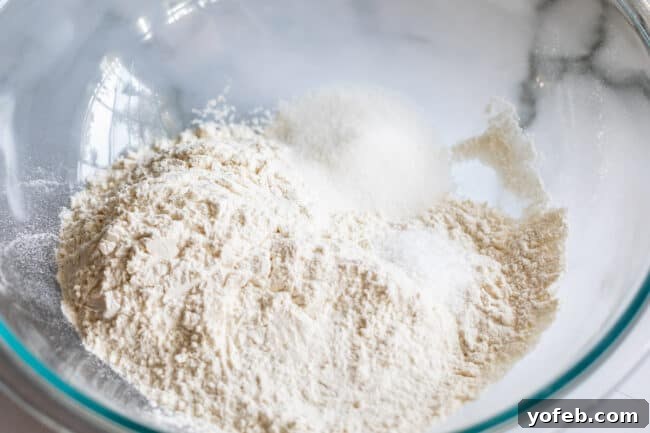 A large bowl containing a mixture of flour, salt, and sugar, prepared for making pie crust.