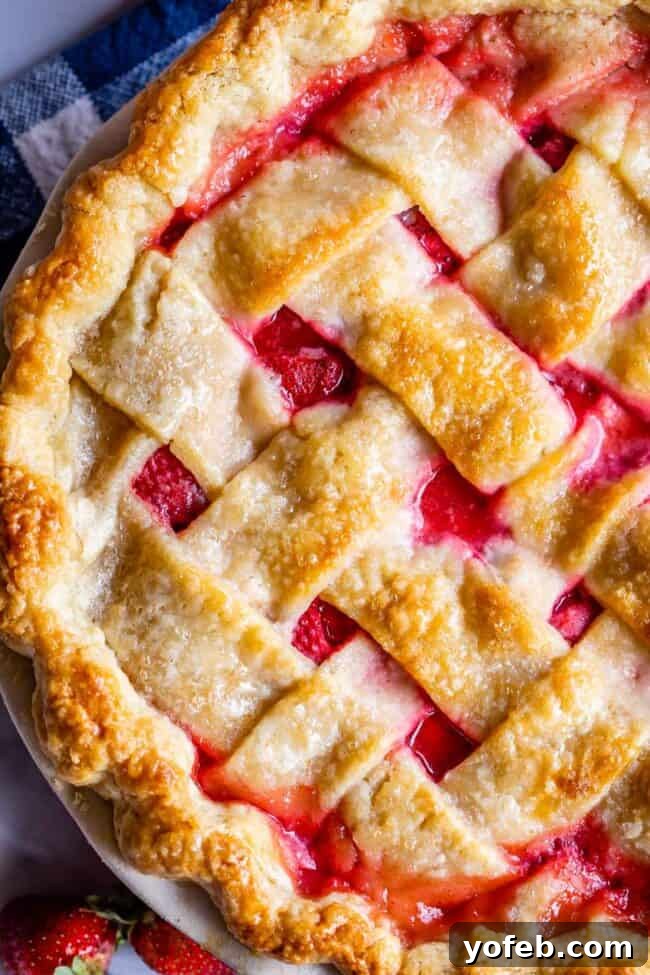 A Visual Guide to Making a Lattice Pie Crust 19 close up overhead shot of strawberry pie with weaved lattice crust