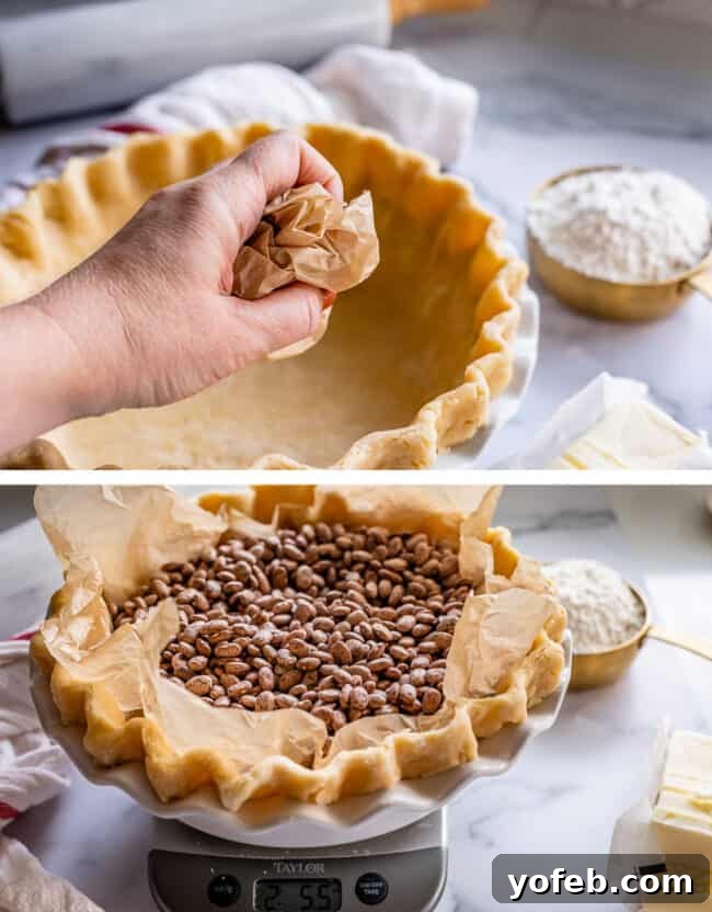 How to Pre-Bake Your Pie Crust Perfectly 7 A close-up of a hand crumpling parchment paper, preparing it to line a pie crust before adding pie weights for blind baking.