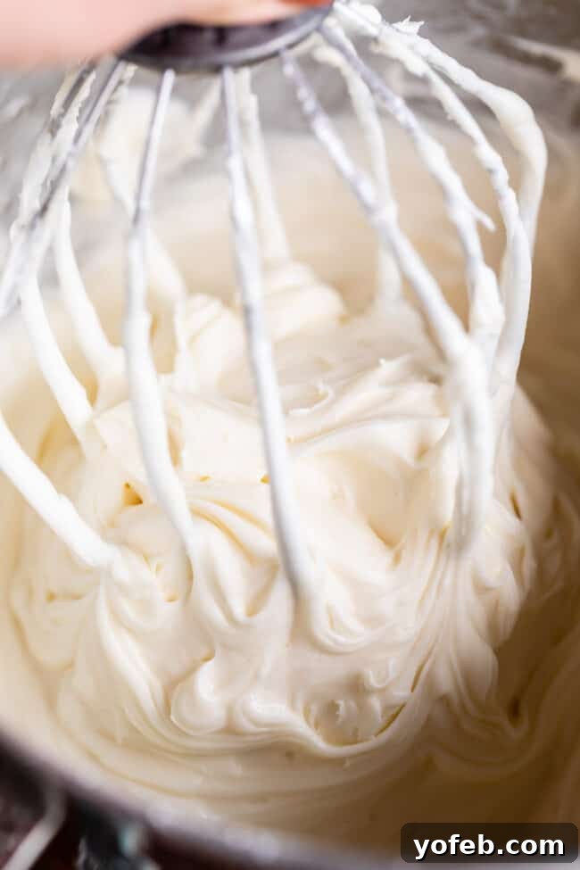 The Ultimate Cream Cheese Frosting 11 Close-up of fluffy cream cheese frosting clinging to a beater.
