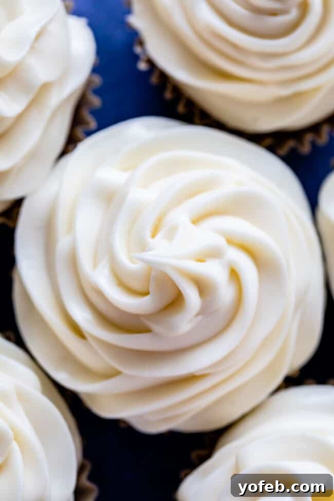 The Ultimate Cream Cheese Frosting 3 Decadent cupcakes generously topped with fluffy cream cheese frosting.