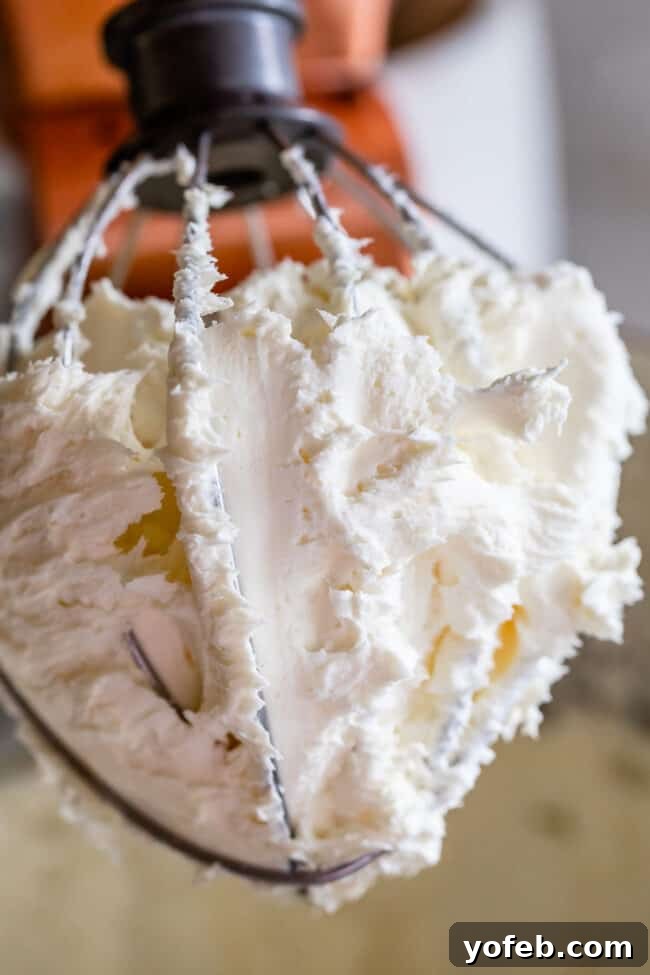 The Ultimate Cream Cheese Frosting 6 Softened butter and cream cheese being beaten together in a stand mixer.