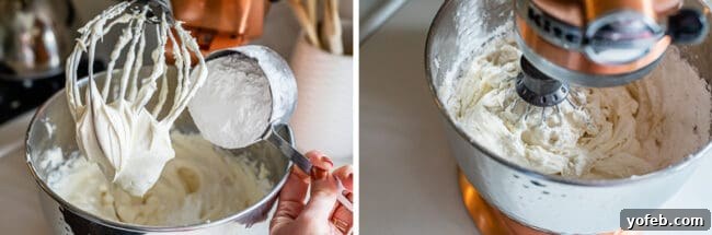 The Ultimate Cream Cheese Frosting 8 Powdered sugar being added to the cream cheese frosting mixture in a stand mixer.