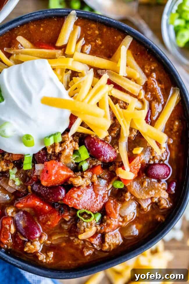 Effortless 45 Minute Chili 14 easy chili recipe in a black bowl with cheese and sour cream.