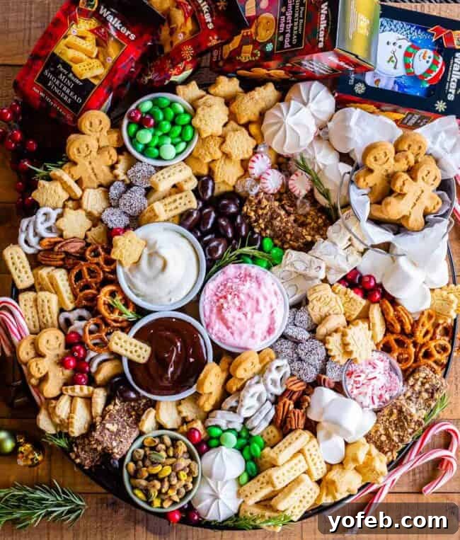 Sweet Grazing Boards 2 A vibrant dessert charcuterie board laden with Walkers Shortbread, an assortment of sweets, and a trio of festive dips, perfect for holiday entertaining.