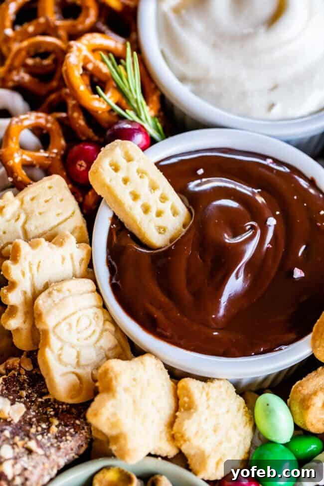 Sweet Grazing Boards 5 A festive dessert board with rich chocolate ganache dip, golden shortbread fingers, and salty pretzels, perfectly complementing the sweet spread.