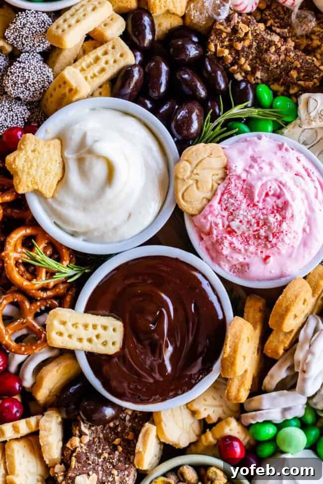 Sweet Grazing Boards 8 An overhead view of three festive sweet dips—chocolate ganache, marshmallow creme, and peppermint whip—arranged on a Christmas-themed dessert platter.