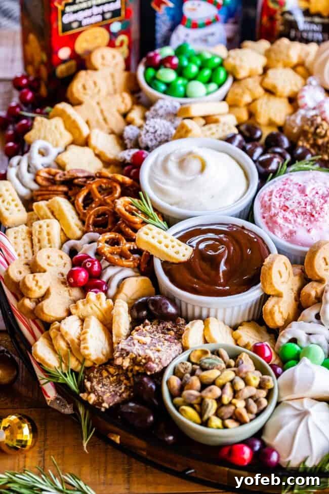 Sweet Grazing Boards 10 A beautifully decorated dessert charcuterie board, adorned with holiday-themed Walkers Shortbread, fresh cranberries, and rosemary, perfect for Christmas celebrations.