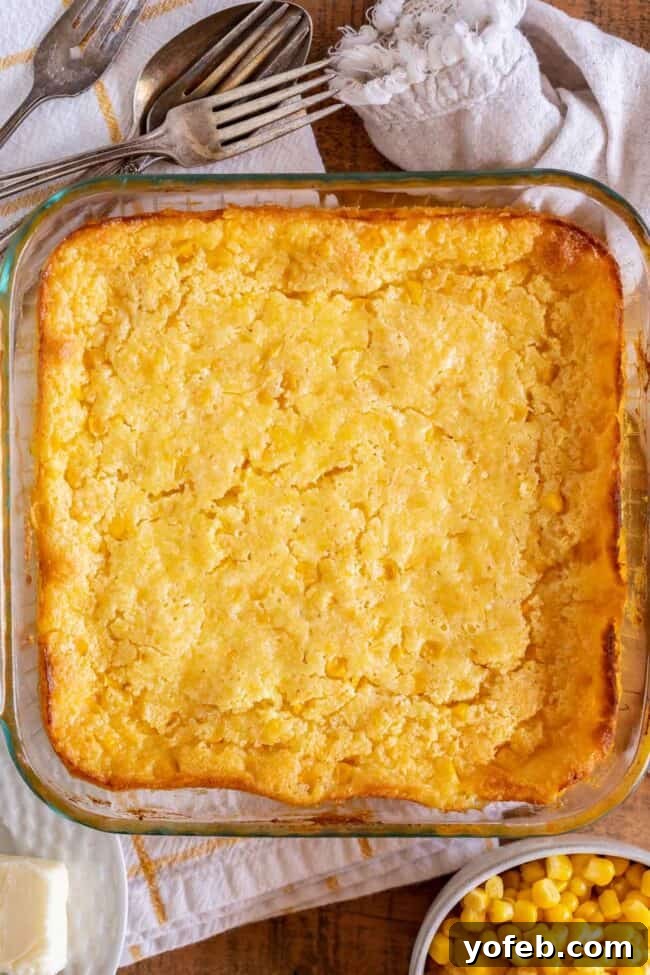Golden Cornbread Delight 14 cream corn casserole recipe in a square glass pan shot from overhead.