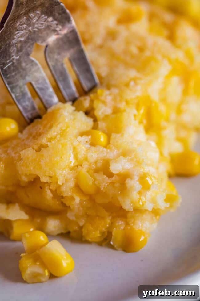 Golden Cornbread Delight 5 close up shot of cream corn casserole with a fork in it.
