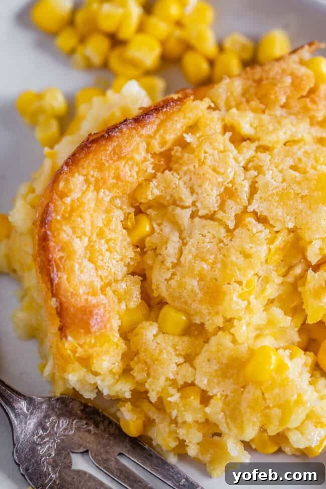 Golden Cornbread Delight 7 jiffy cornbread casserole on a plate with a fork.