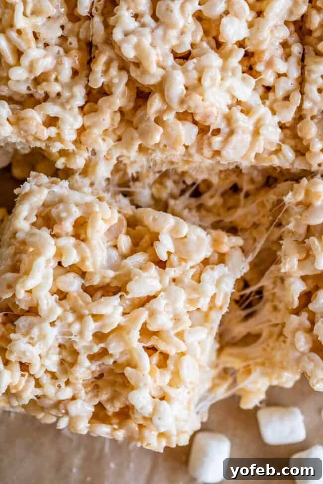 Foolproof Rice Krispies Treats 8 Separating a square of soft Rice Krispie Treat from the rest of the batch.