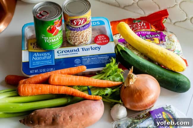 A vibrant selection of fresh ingredients for Weight Loss Soup, including various vegetables, lean ground turkey, and canned white beans.