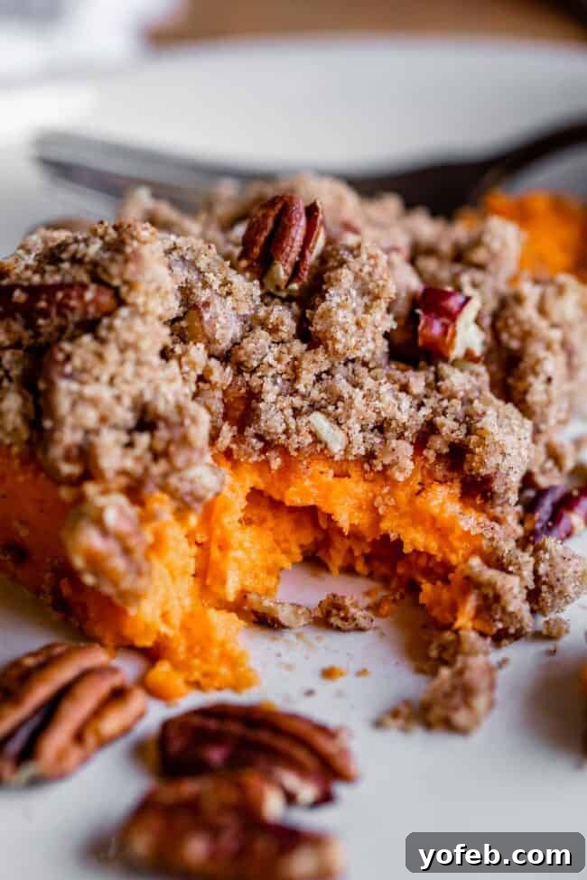 Heavenly Sweet Potato Crumble 2 Sweet potato casserole with a generous pecan streusel topping, showcasing its golden-brown crust and creamy interior.