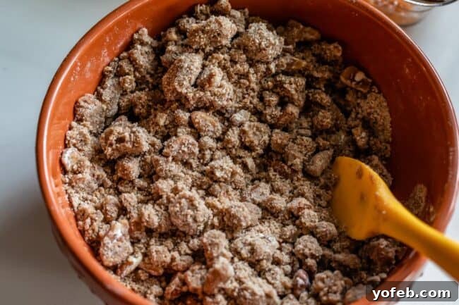 Heavenly Sweet Potato Crumble 11 A bowl of rich brown sugar streusel with a spoon, showing its crumbly texture.
