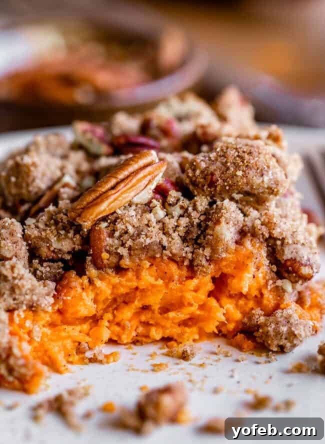 Heavenly Sweet Potato Crumble 13 A plate with a serving of sweet potato casserole, showing a few bites already taken, highlighting its appeal.