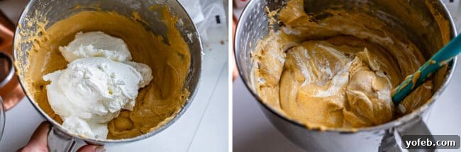 Gently folding whipped cream into the pumpkin cheesecake batter using a spatula.